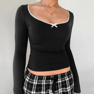 Slim fit black long sleeve top featuring a scoop neck with white lace trim and bow detail