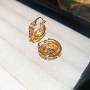 Detail of 18K gold plated double hoop earrings with colorful zircon stones in a jewelry box