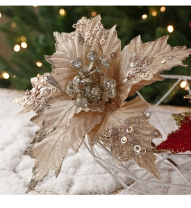 Close-up of champagne Christmas flower with silver sequins on a bokeh festive background