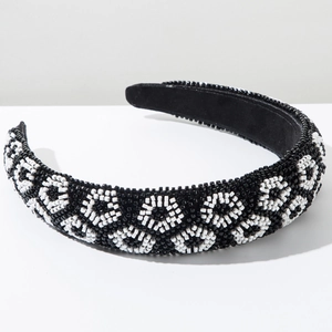 Close-up of beaded headband showing black and white geometric diamond pattern and velvet lining