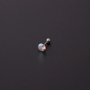 Macro detail of a 2-5mm AB colored zircon earring with a secure screw ball back closure