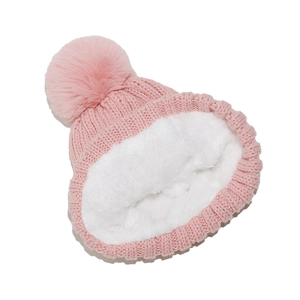 Detailed view of pink knitted beanie featuring thick white faux fur lining and pom-pom