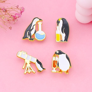 Set of four cute penguin enamel pins with telescope and glass on pink background