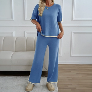 Women's blue knit two-piece set with yellow contrast trim short sleeve top and wide-leg pants
