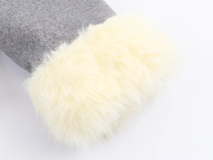 Close-up of grey textile jacket with premium cream faux fur trim detailing