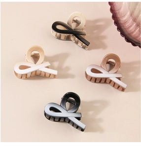 Macro view of four elegant gradient hair clips with metal springs and glossy finish