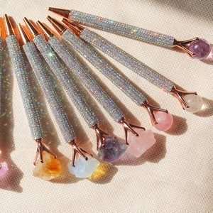 Elegant crystal ballpoint pens with silver rhinestones and raw gemstone tops in fan layout