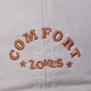 Cotton baseball cap with brown Comfort Zones embroidery and soft grey twill texture