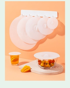 Set of translucent white food-grade silicone lids in various sizes for kitchen use