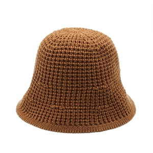 Detailed view of the hollow honeycomb knit pattern on a caramel brown sun hat
