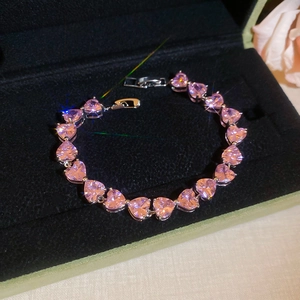 Pink heart crystal bracelet displayed on black velvet inside a luxury gift box