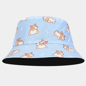 Detail of light blue bucket hat with cute corgi pattern and reversible black interior lining