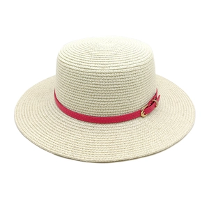Straw boater hat in beige with pink leather strap and gold buckle for beach vacation