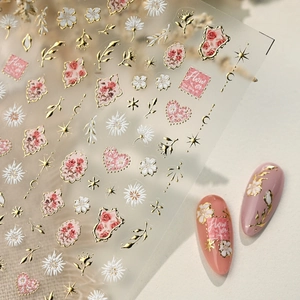 French floral nail stickers with gold stars and pink flowers on transparent base
