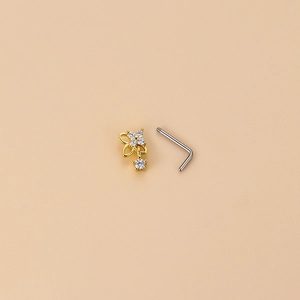 L-shaped stainless steel nose stud with a golden flower pendant and clear zircon stones