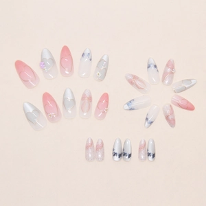 Detail of pink cat eye press-on nails with floral heart design and pearl accents
