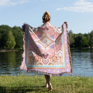 Outdoor view of a bohemian jacquard blanket with colorful floral patterns and long tassels