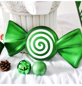 Detail of green Christmas candy ornament with pine cone and glittery decorative spheres