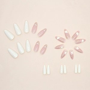 Almond-shaped press-on nails with white French tips and minimalist heart patterns
