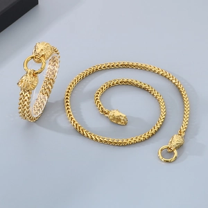 Detailed view of golden stainless steel lion head bracelet and necklace set for men