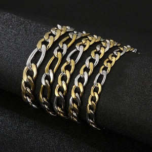 Two-tone gold and silver Figaro link chains in five widths on a black display stand