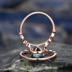 Elegant rose gold wedding ring set with round teal gemstone and pavé diamonds