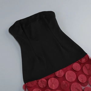 Detailed view of the red 3D floral petals and patchwork hem on the strapless dress