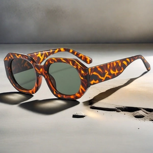 Side view of retro polygon sunglasses with tortoise frame and dark green lenses