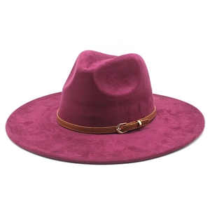 Detailed close-up of wide brim fedora hat featuring brown leather band and gold buckle