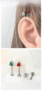 Detailed view of titanium ear studs with colorful zircon triangle stones and flat back post
