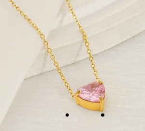Close-up of pink heart-shaped zircon pendant with gold-plated stainless steel chain