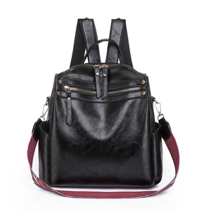 Fashionable black PU leather backpack with colorful woven strap and gold zipper details