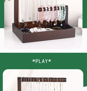 Detail view of walnut wood jewelry organizer with metal hooks for hanging necklaces