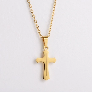 Minimalist gold titanium steel cross pendant necklace on a clean white background