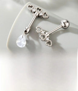 Detailed view of silver titanium steel ear studs with zircon water drop pendant