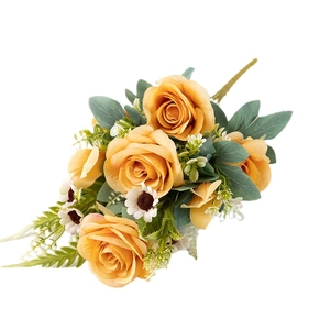 Artificial bouquet with orange roses, white daisies, and green leaves on white background