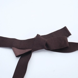 Detail view of the dark brown ribbed knit fabric texture and horizontal striping pattern