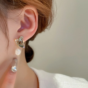 Vintage gold butterfly earrings with zircon and baroque freshwater pearl on model