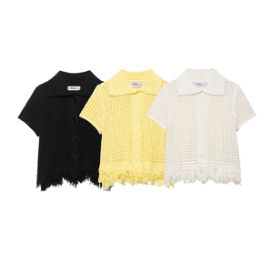 Détail d'un haut en maille ajourée avec franges et col polo en plusieurs coloris