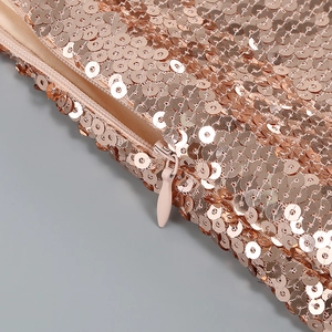Detailed macro view of rose gold sequins fabric featuring a matching invisible zipper