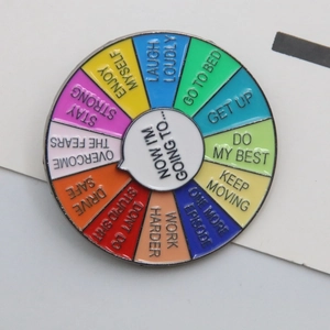 Macro view of rotating enamel mood pin with colorful sections and motivational text phrases