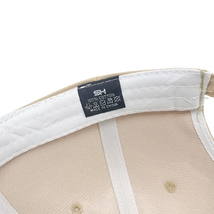 Detail view of khaki cotton baseball cap interior featuring sweatband and wash label