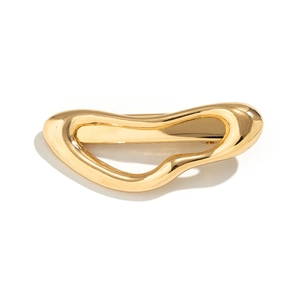 Minimalist irregular golden metal hairpin with polished geometric design on white background