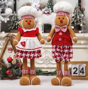 Close-up of plush gingerbread man and woman dolls in a festive Christmas scene