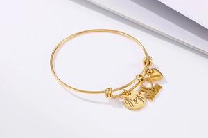 Detail of gold adjustable bracelet with I Love Mom heart charms and family pendant