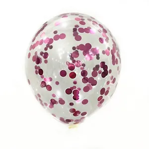 Close-up of transparent latex balloon filled with vibrant magenta round foil sequins