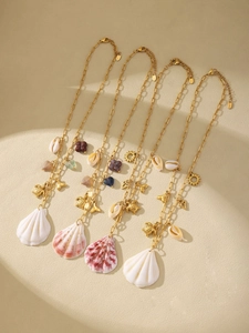 Detailed view of gold stainless steel necklaces with shell, turtle and starfish pendants