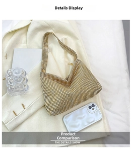 Close-up of golden rhinestone shoulder bag size comparison with a smartphone