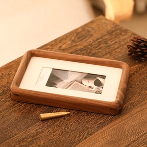 Detail of walnut wood photo frame with mortise-tenon joint and brass support rod