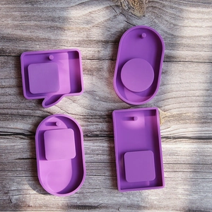 Set of four purple silicone molds for DIY phone grip pendants in various shapes